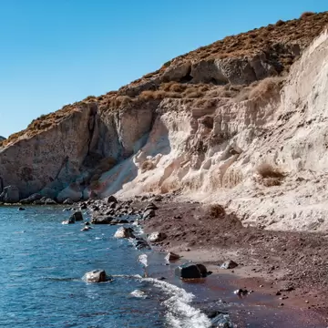 View of the water at the White (Aspri) Beach on the island of Santorini in Greece.