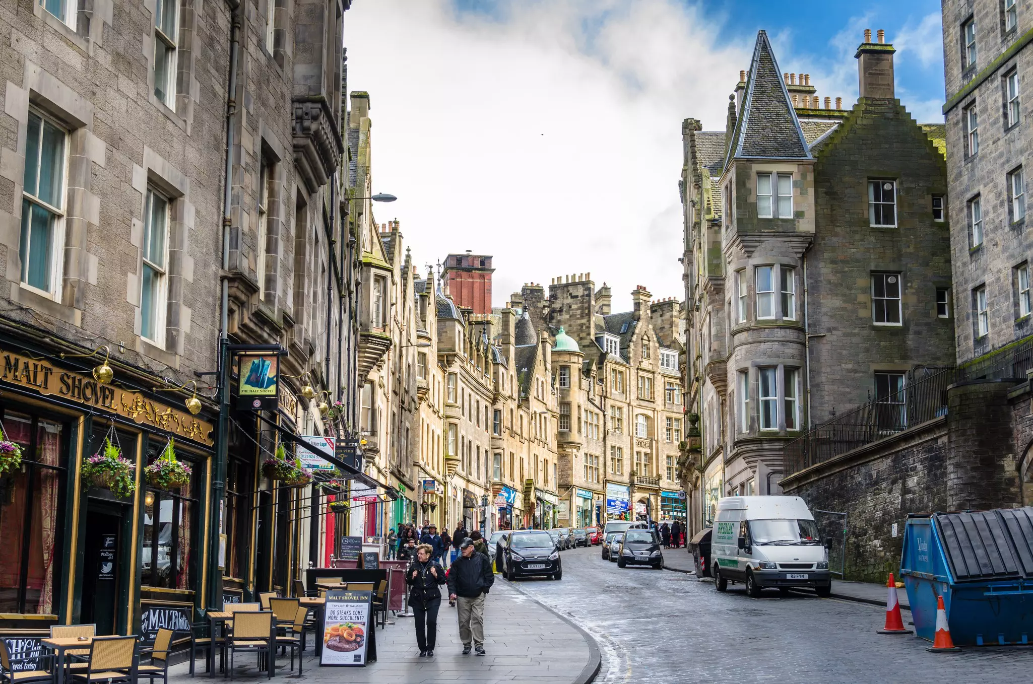 Tourists stroll along a cobbled street