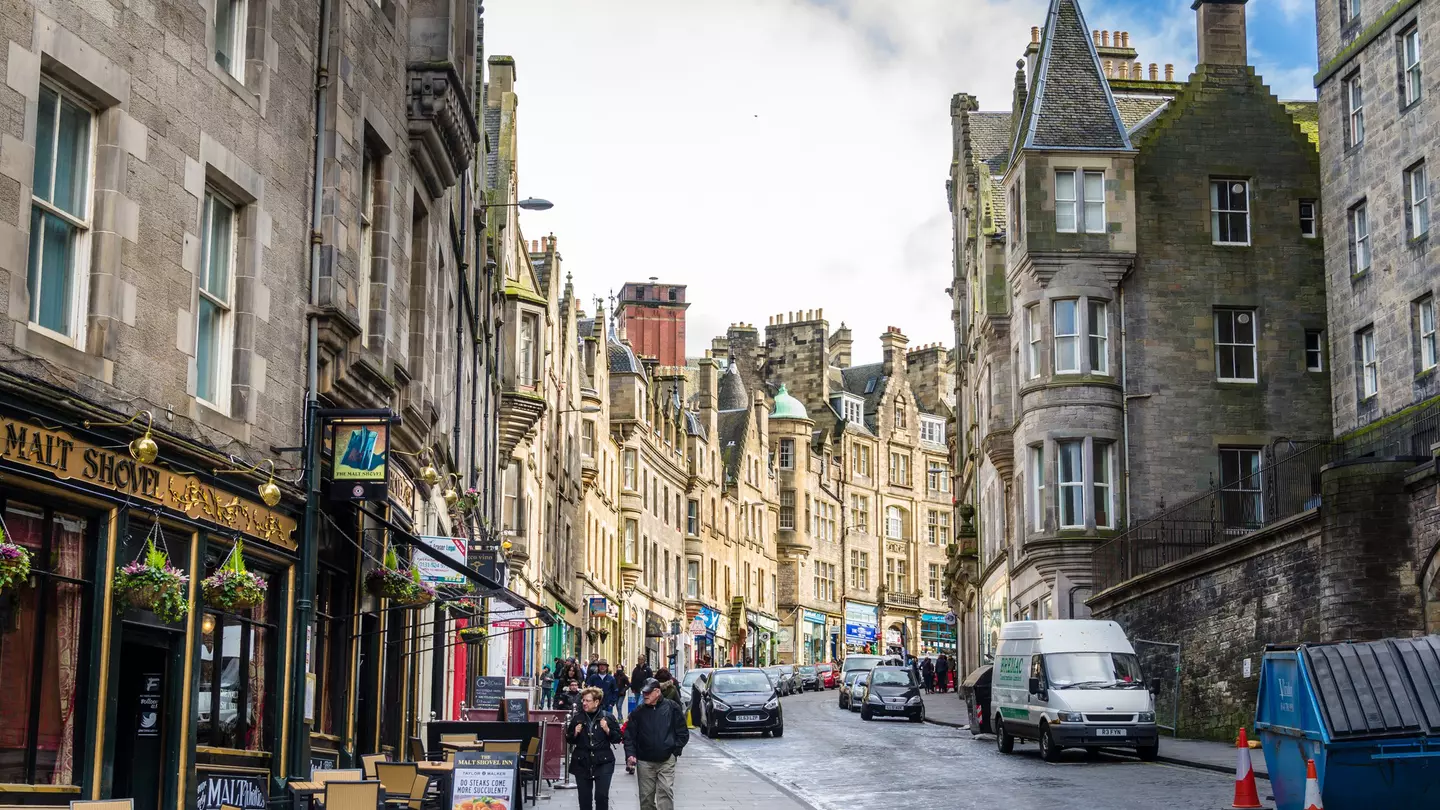 Tourists stroll along a cobbled street