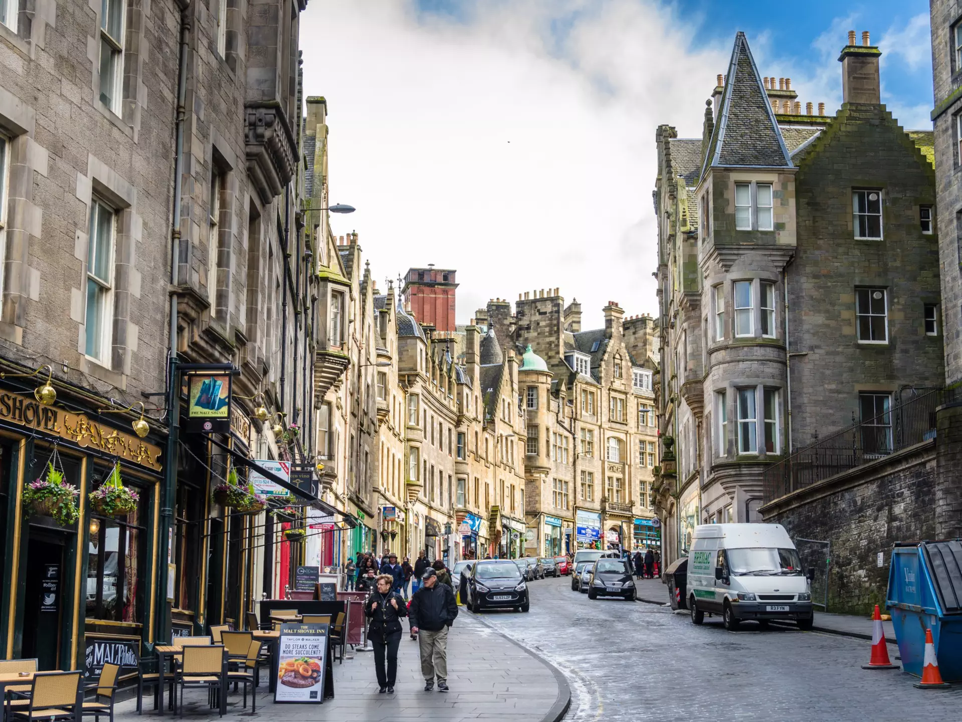 Tourists stroll along a cobbled street
