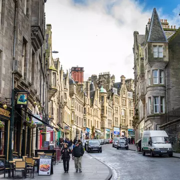 Tourists stroll along a cobbled street