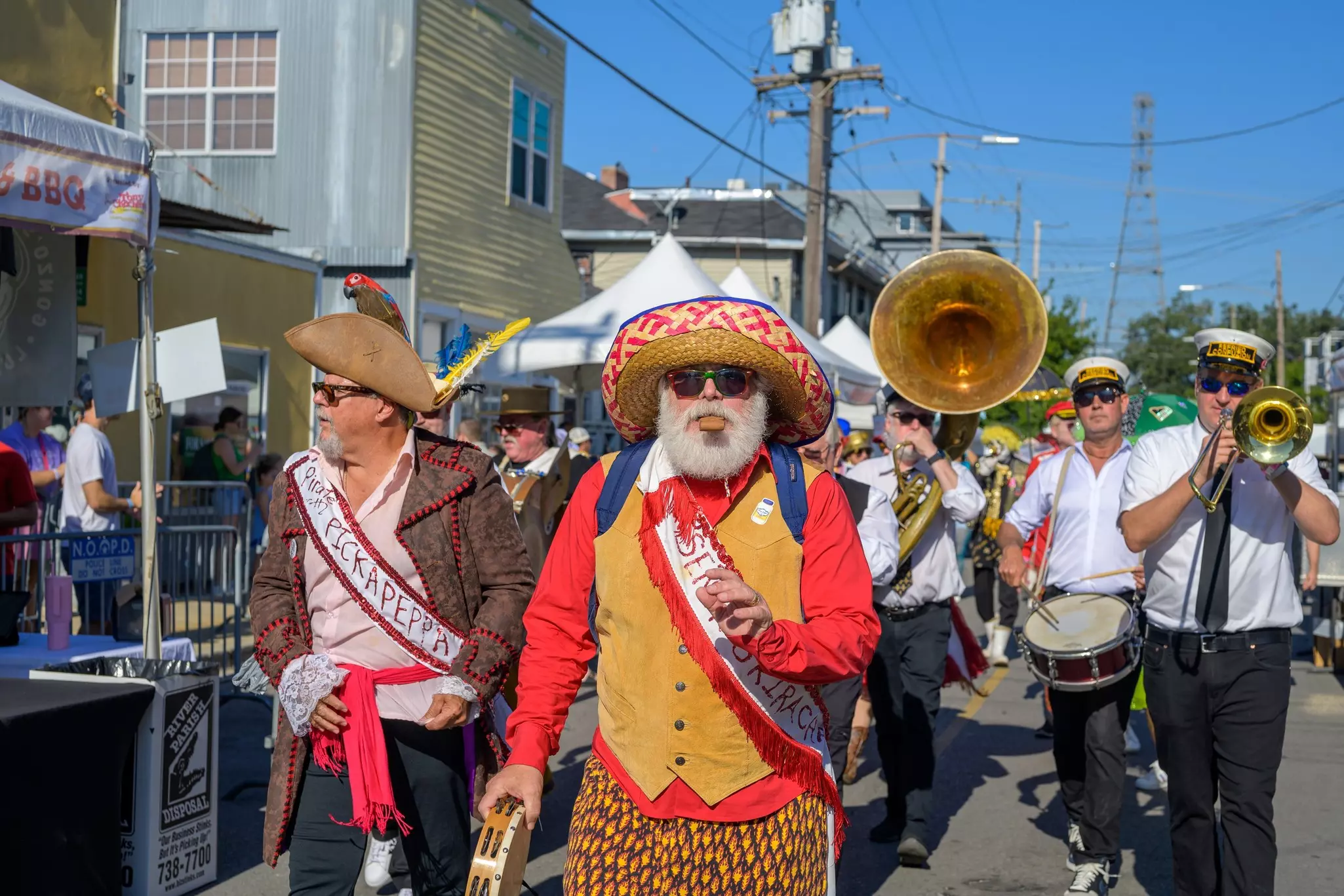 The Po-Boy Festival on Oak Street, with a marching band and men in colorful outfits
