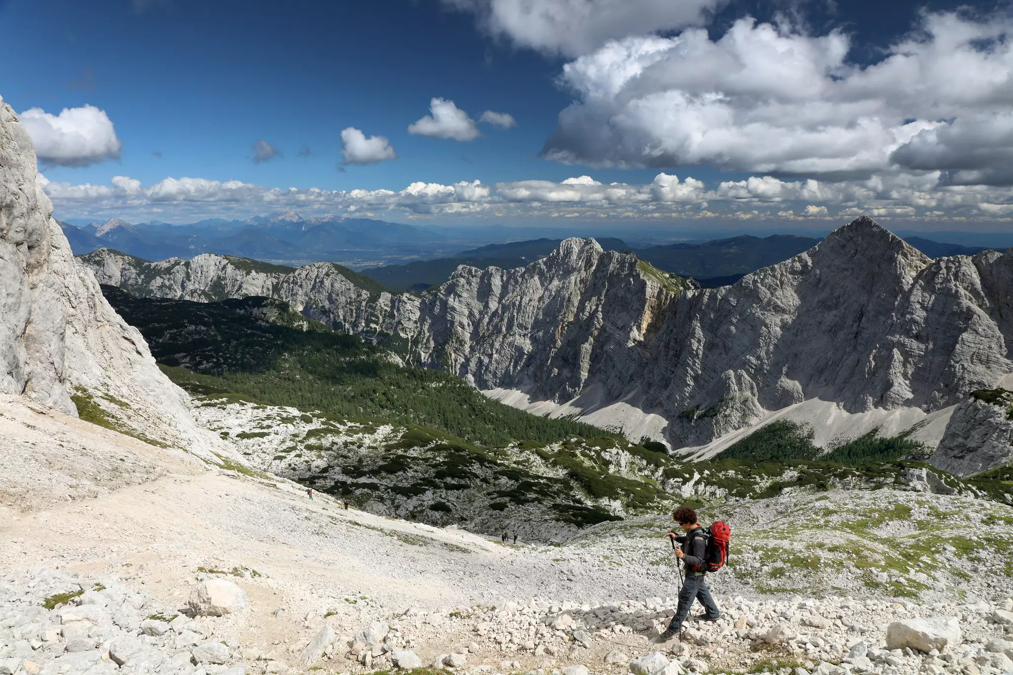 A hiker in Triglav National Park with clouds overhead