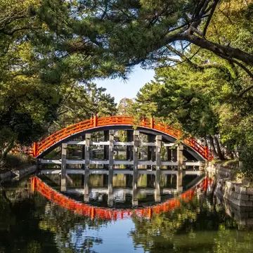 Red Sumiyoshi Taisha Sorihashi Bridge is a picturesque red bridge with a high arch that spans a tranquil pond in Osaka, Japan., License Type: media, Download Time: 2026-05-28T19:45:07.000Z, User: LP_NZhan, Editorial: false, purchase_order: 65050 - Digital Destinations and Articles, job: App Content, client: Lonely Planet App, other: Nadine Zhan
