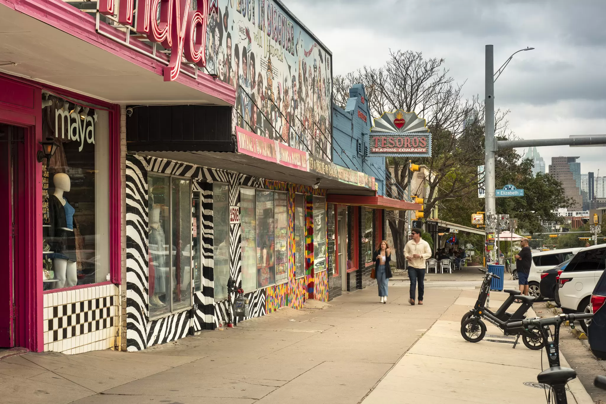 People walk along the trendy South Congress Avenue by colorful shops and restaurants in Austin, Texas.