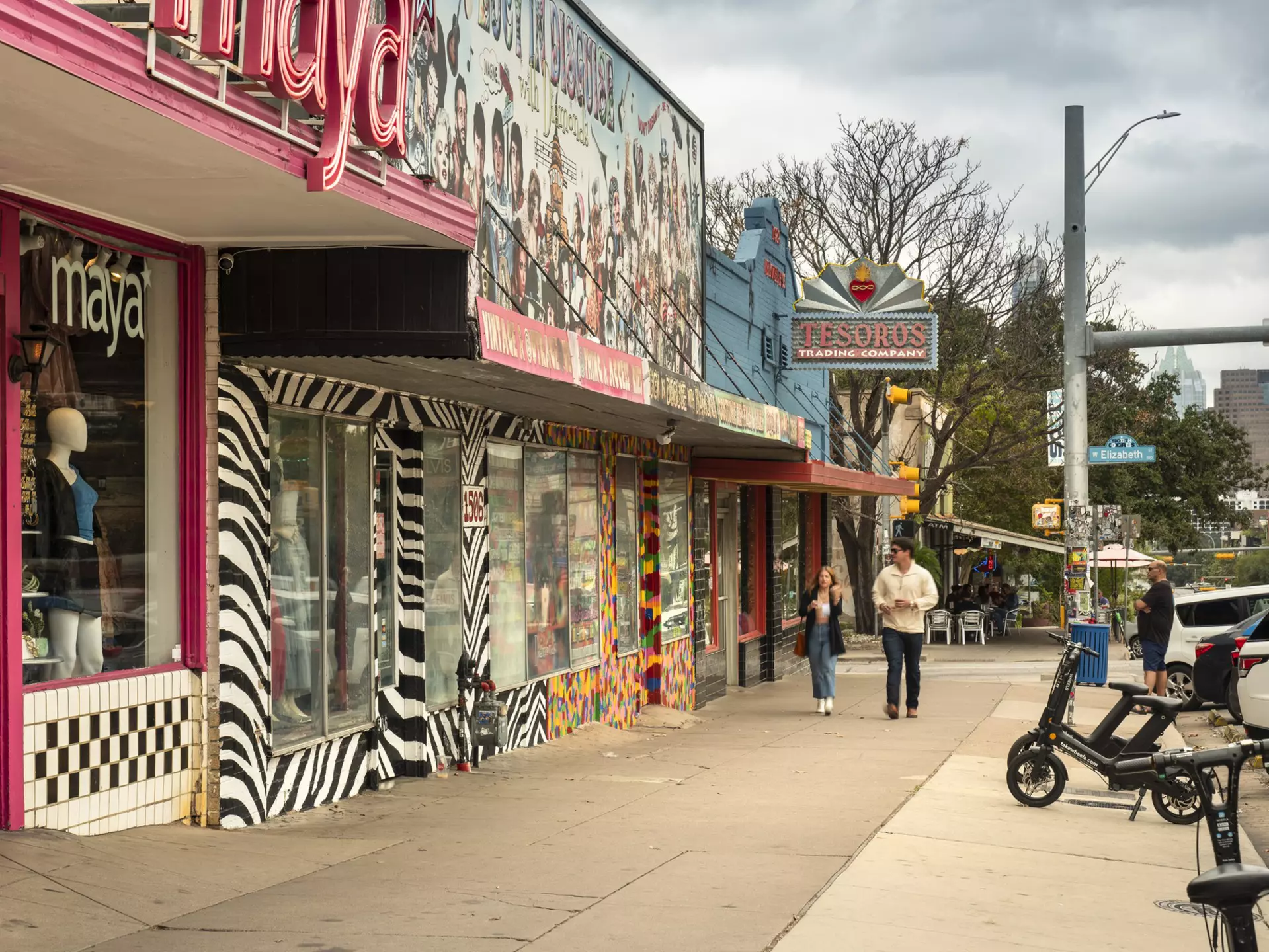 People walk along the trendy South Congress Avenue by colorful shops and restaurants in Austin, Texas.