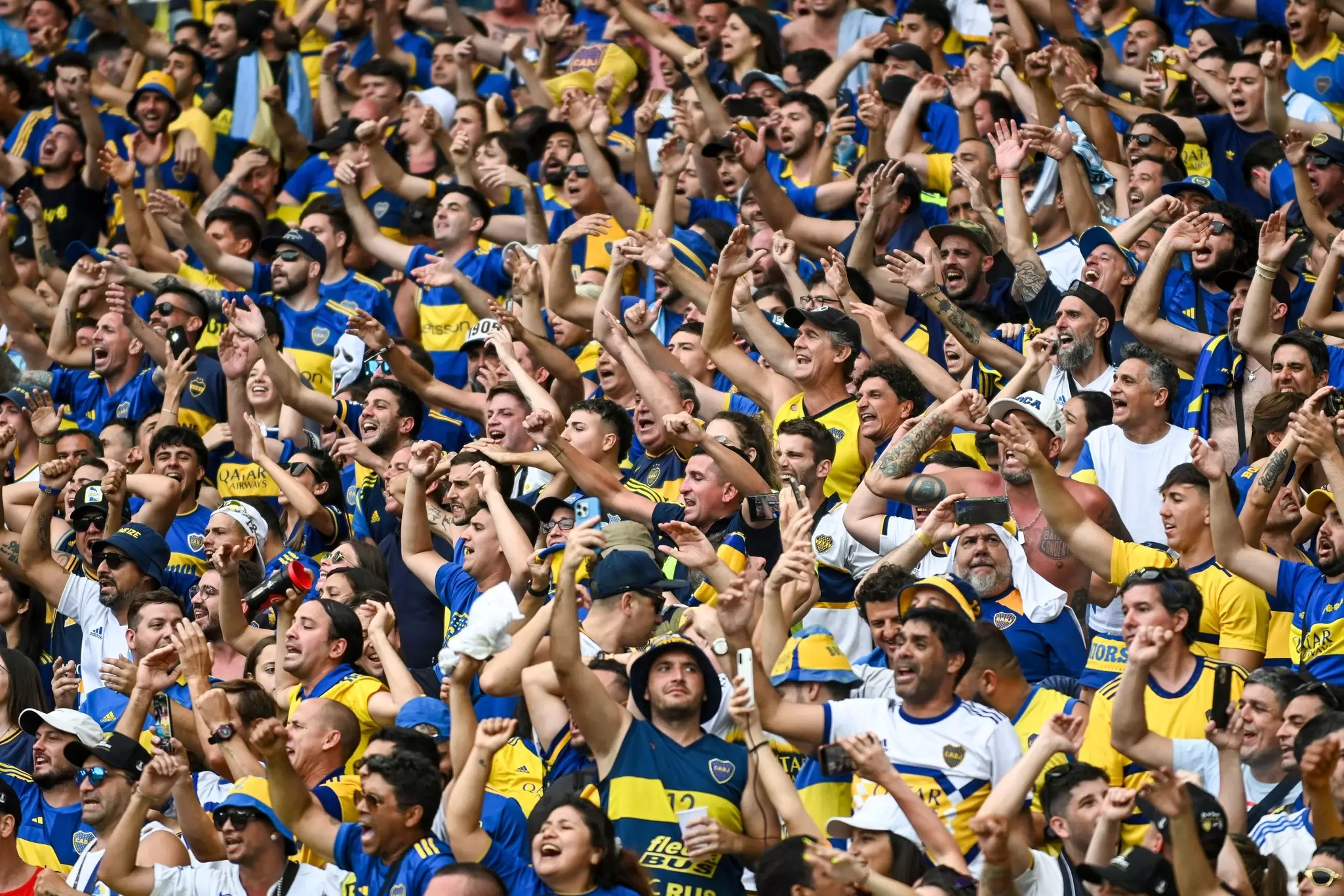 Soccer fans wear blue and yellow jerseys for their local Argentina team. 