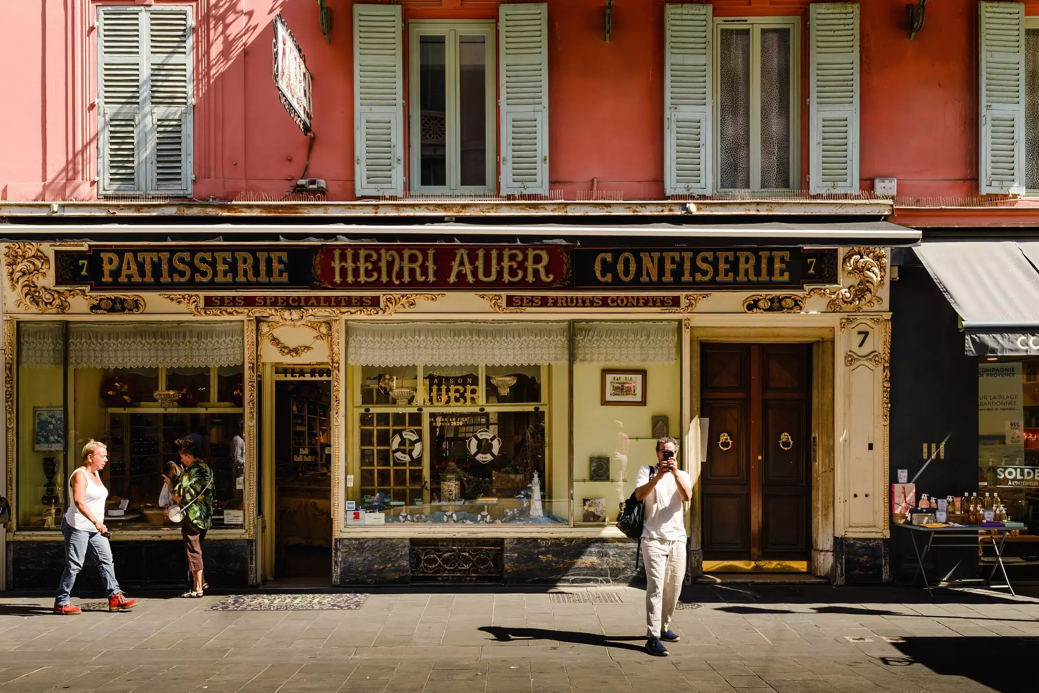 People outside Henri Auer Patisserie and Confectionery in Nice, France