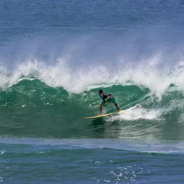 A surfer riding the big waves at Santa Catalina in Panama.