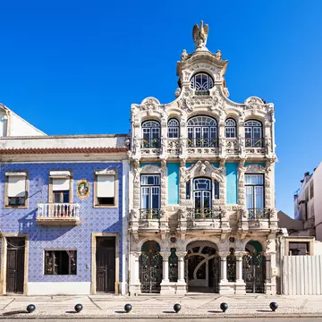 Ornate exterior of a museum building with detailed columns and wrought-iron features over balconies