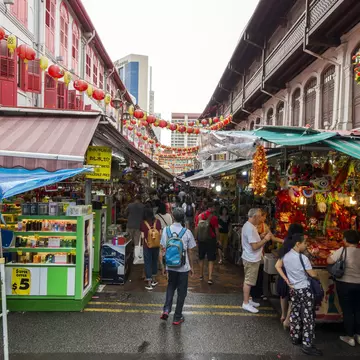 A traveller walking through Chinatown. Tapsiful / Getty