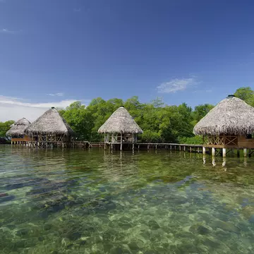 Cabins on the tropical waters of Coral Key, Bastimentos Marine Park.