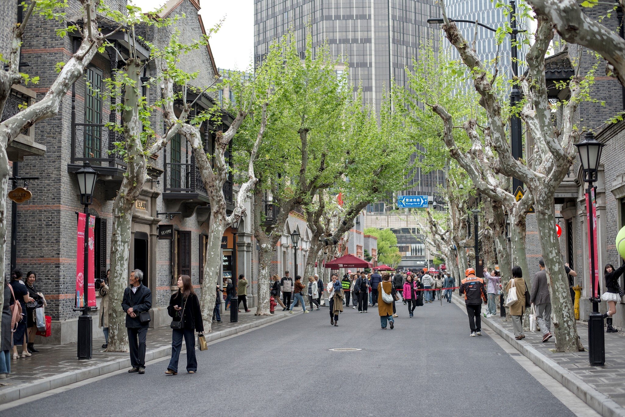 Xintiandi, Shanghai, China, Apr 23, 2026: An interior symmetrical shot of a modern multi-story building atrium, featuring a large glass window wall with a view of outside green trees, indoor balconies, and people walking inside., License Type: media, Download Time: 2026-08-25T15:28:50.000Z, User: LP_NZhan, Editorial: true, purchase_order: 65050 - Digital Destinations and Articles, job: Nadine Zhan, client: Lonely Planet App, other: Nadine Zhan 