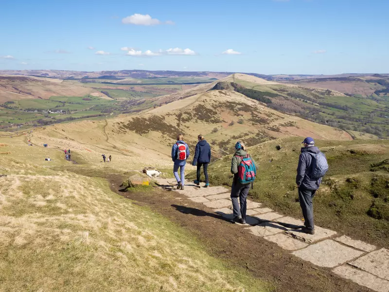 CASTLETON, PEAK DISTRICT NATIONAL PARK, DERBYSHIRE, ENGLAND - APRIL 06, 2018: Walkers on the Great Ridge walk heading towards Lose Hill with views of the Edale and Hope valleys  License Type: media  Download Time: 2023-06-13T23:42:44.000Z  User: mvm_lonelyplanet  Is Editorial: Yes  purchase_order:  56530/Global Publishing-WIP  
