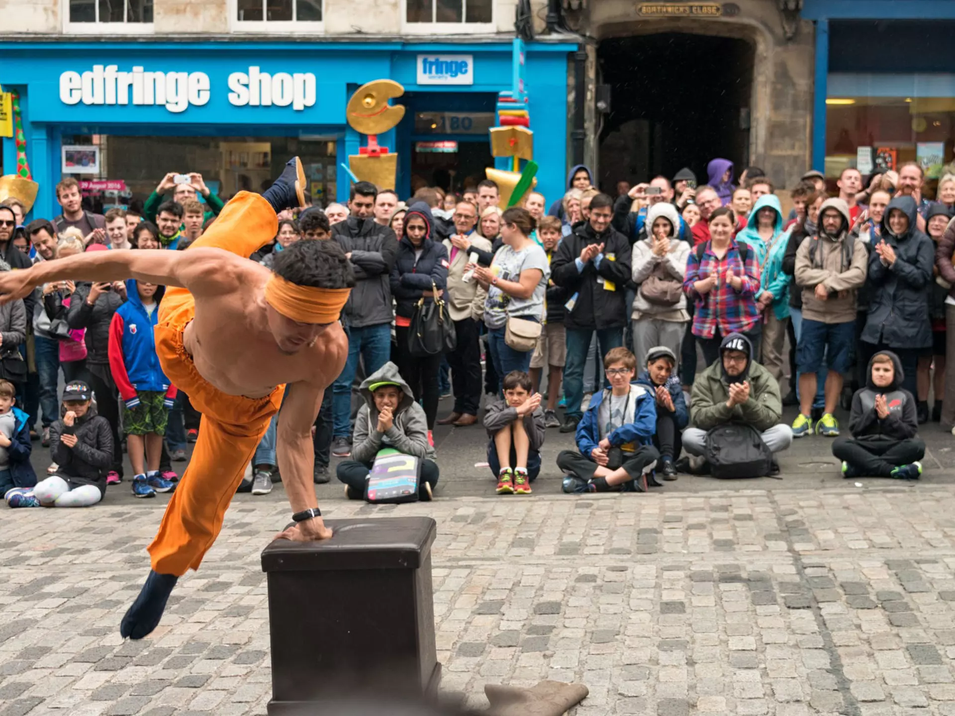 A large sock store with piles of socks on several tables and hanging on the walls