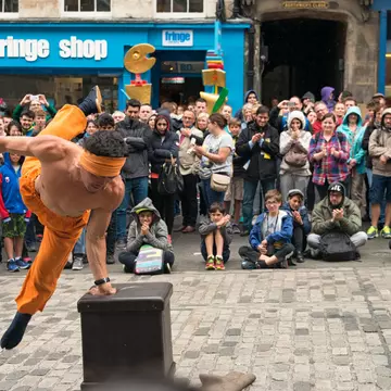 A large sock store with piles of socks on several tables and hanging on the walls