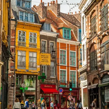  Busy street in Lille's old town with shoppers on a sunny summer day 