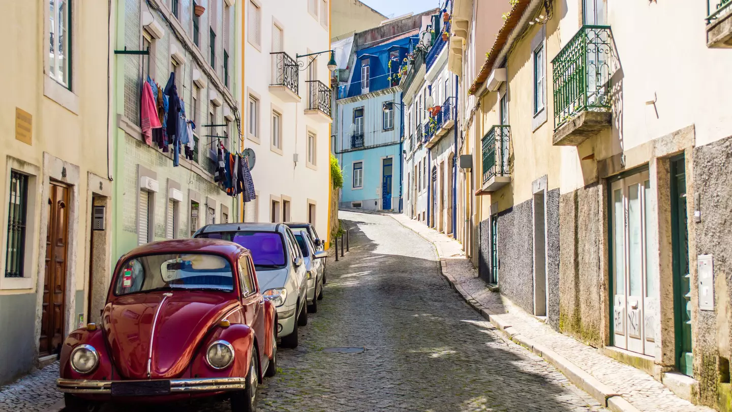 Portuguese street with old classic vintage VW beetle car in Lisbon, Portugal