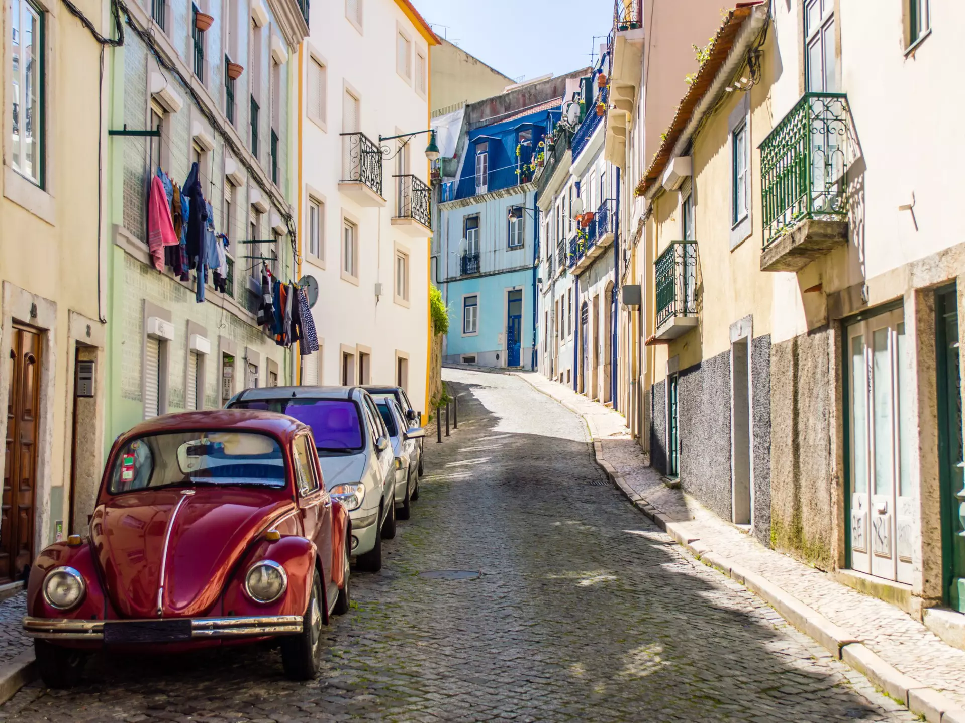 Portuguese street with old classic vintage VW beetle car in Lisbon, Portugal