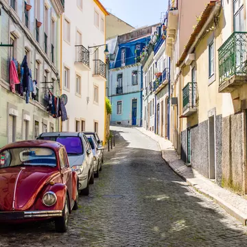 Portuguese street with old classic vintage VW beetle car in Lisbon, Portugal