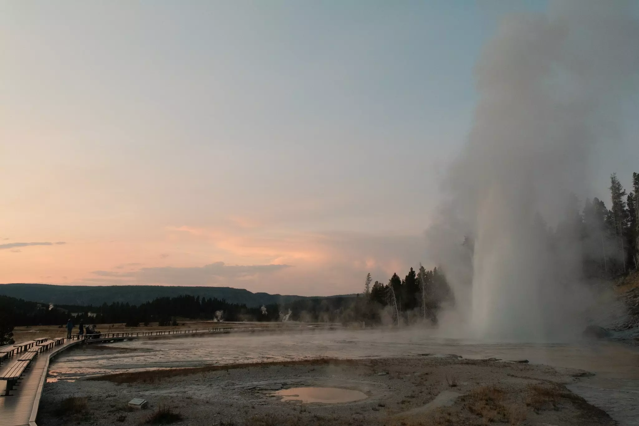 A geyser erupts at dusk