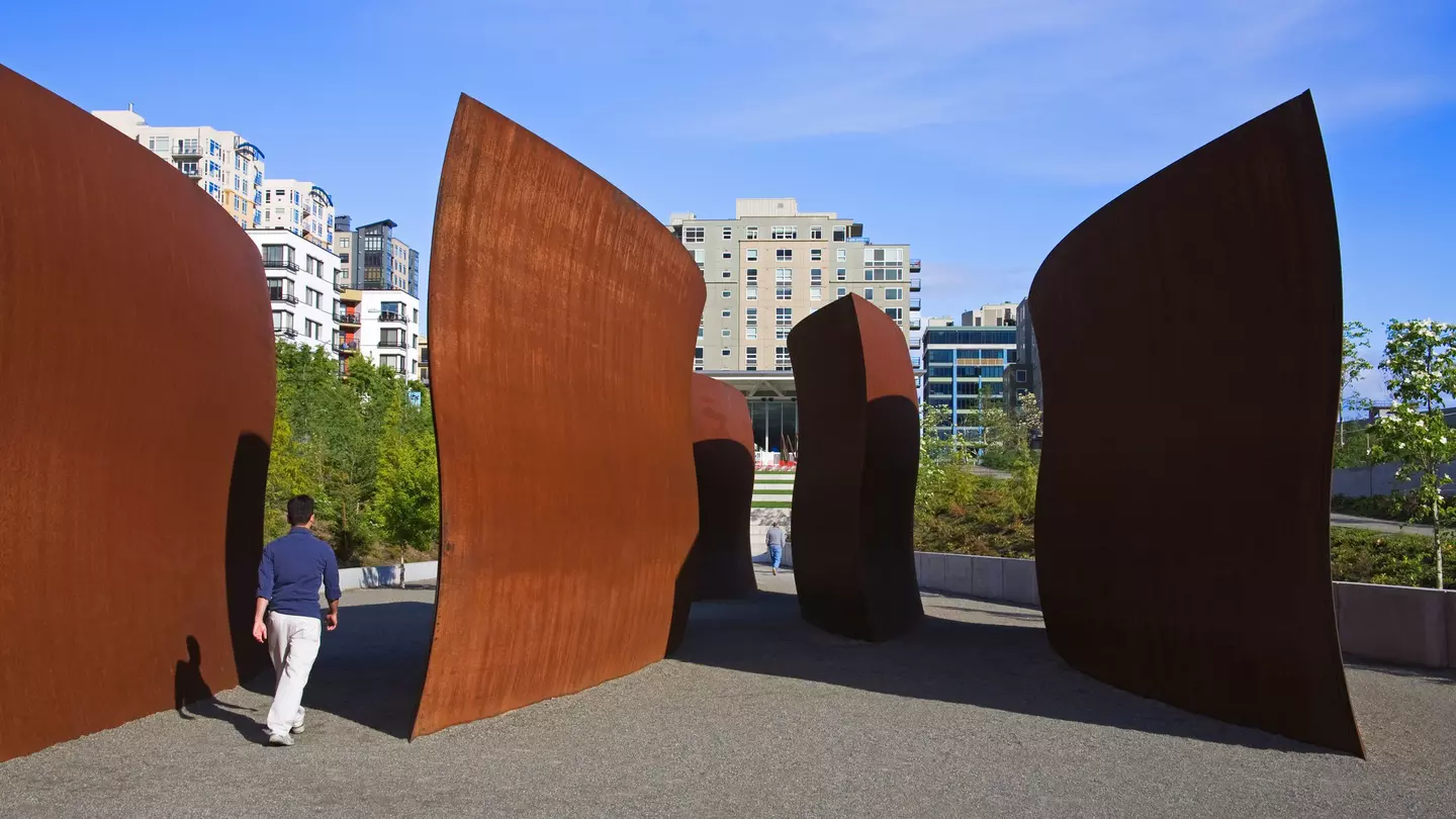 Person walking around sculptures at Olympic Sculpture Park in Seattle