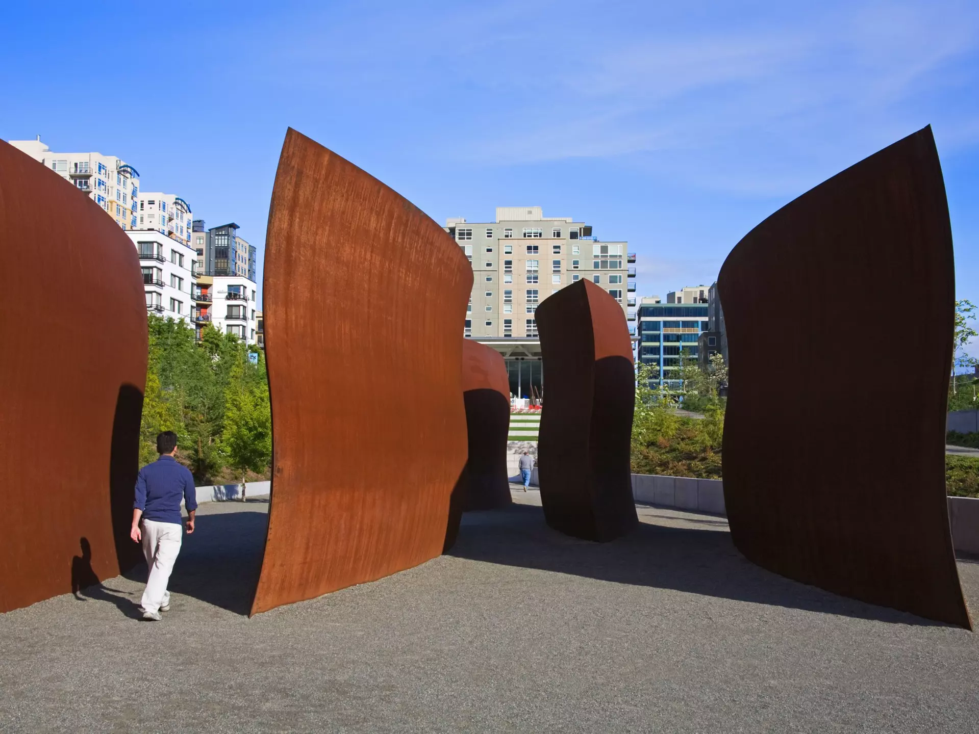 Person walking around sculptures at Olympic Sculpture Park in Seattle