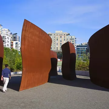 Person walking around sculptures at Olympic Sculpture Park in Seattle
