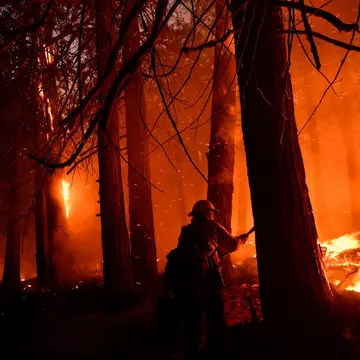A Kern County firefighter uses a hand tool to keep the fire from spreading as trees burn at night during the French Fire in the Sequoia National Forest near Wofford Heights, California on August 25, 2021. - The wildfire west of Lake Isabella in Kern County has burned over 20,000 acres while threatening homes in and around Wofford Heights and Kernville. (Photo by Patrick T. FALLON / AFP) (Photo by PATRICK T. FALLON/AFP via Getty Images)
1234870154
fire, Horizontal