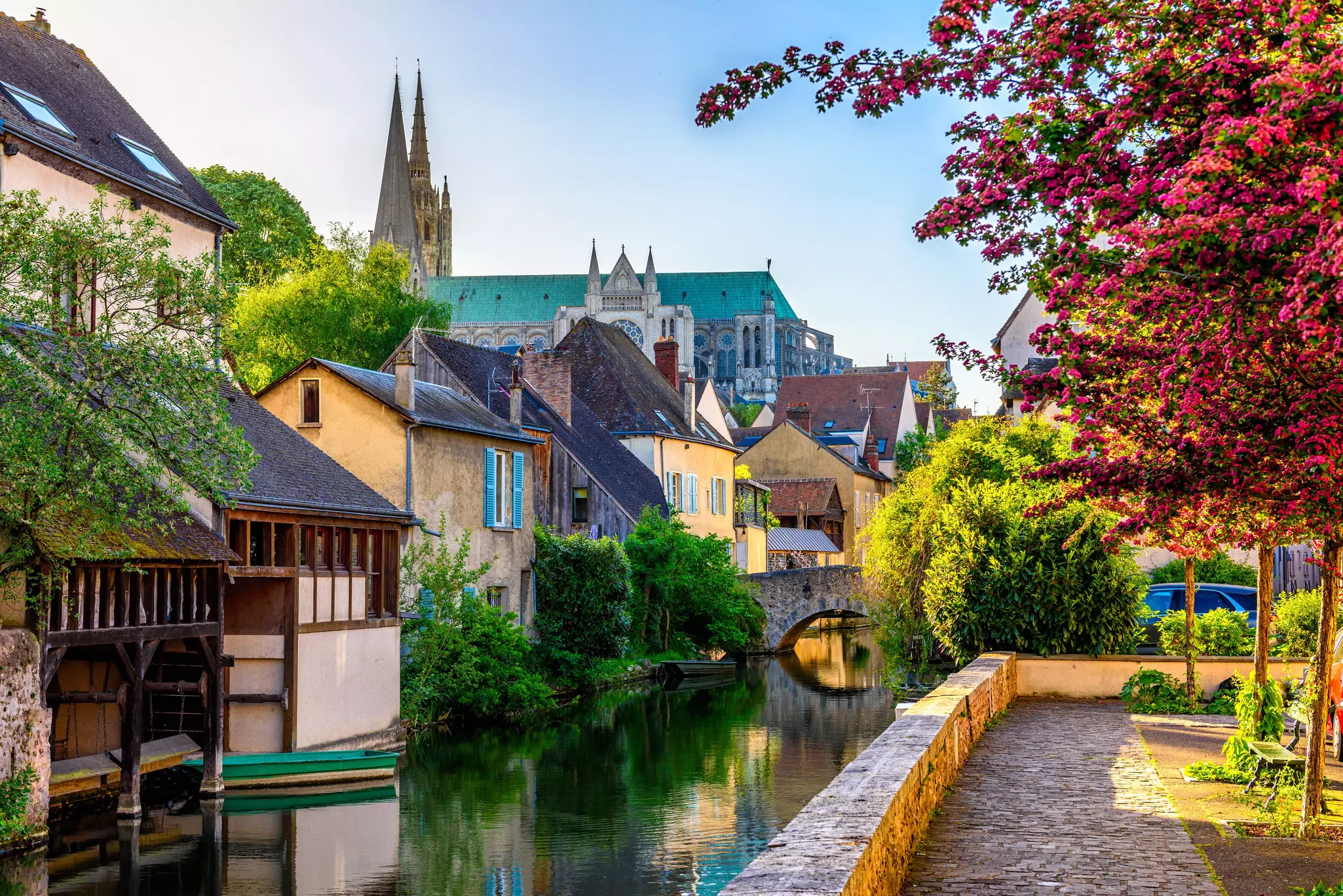 Eure River embankment with old houses and Notre-Dame de Chartres Cathedral in Chartres, France