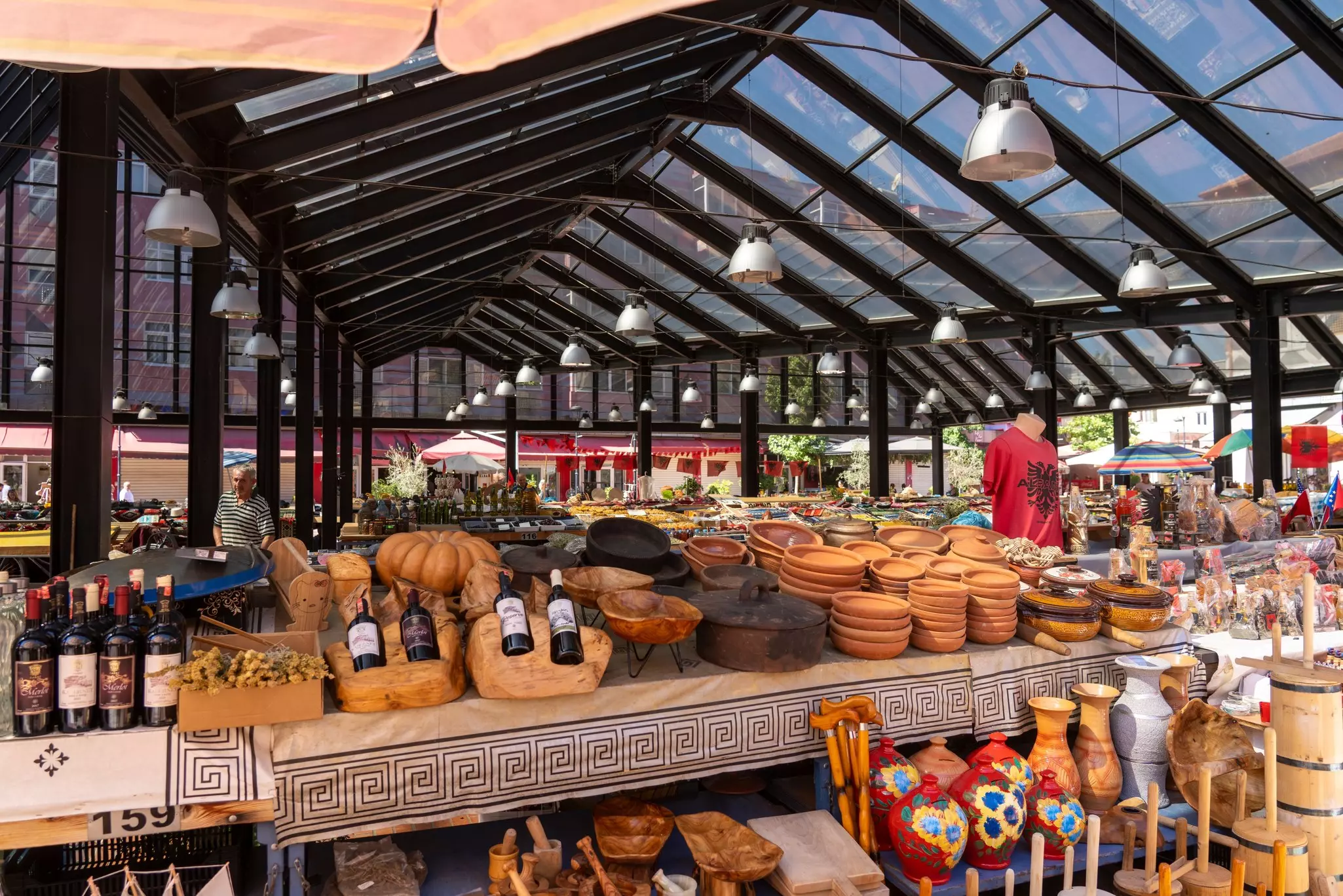 Wooden and earthenware for sale at a covered market in Albania.
