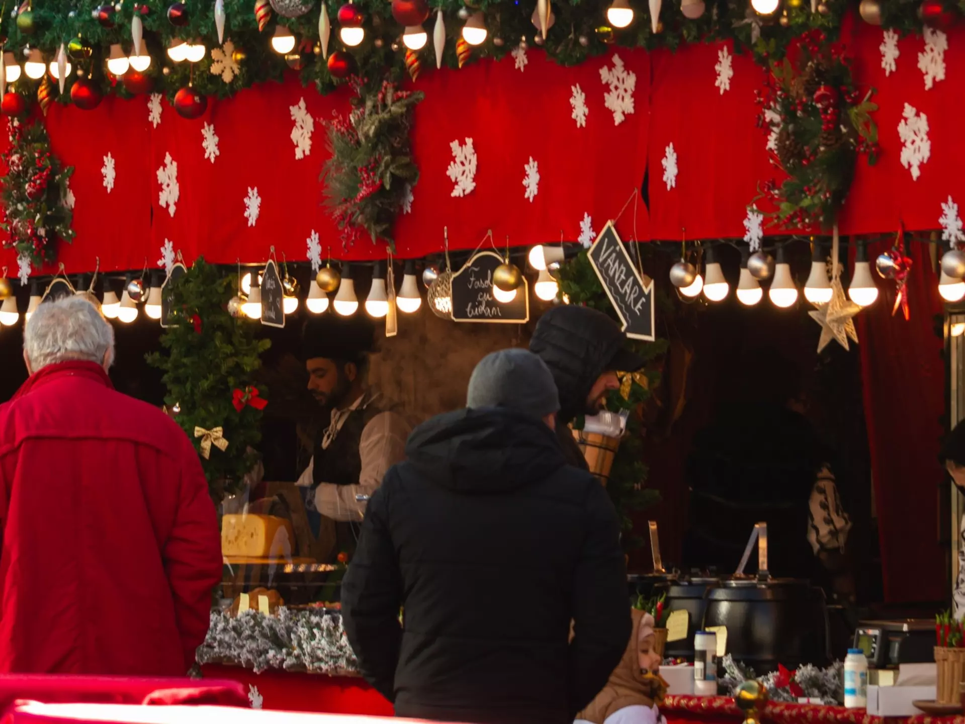 Christmas fair in winter. Traditional decorated Christmas fair kiosk with food cooked on site. People buy traditional food at the Christmas Market stall. Sibiu, Romania, December 18, 2023, License Type: media, Download Time: 2025-03-17T20:51:10.000Z, User: katelyn.perry_lonelyplanet, Editorial: true, purchase_order: 65050 - Digital Destinations and Articles, job: wip, client: wip, other: Katelyn Perry