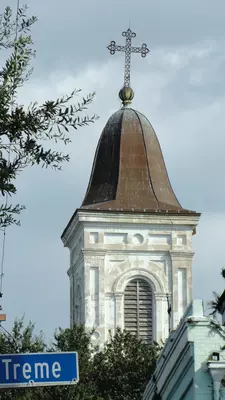 A white church tower with a clock.