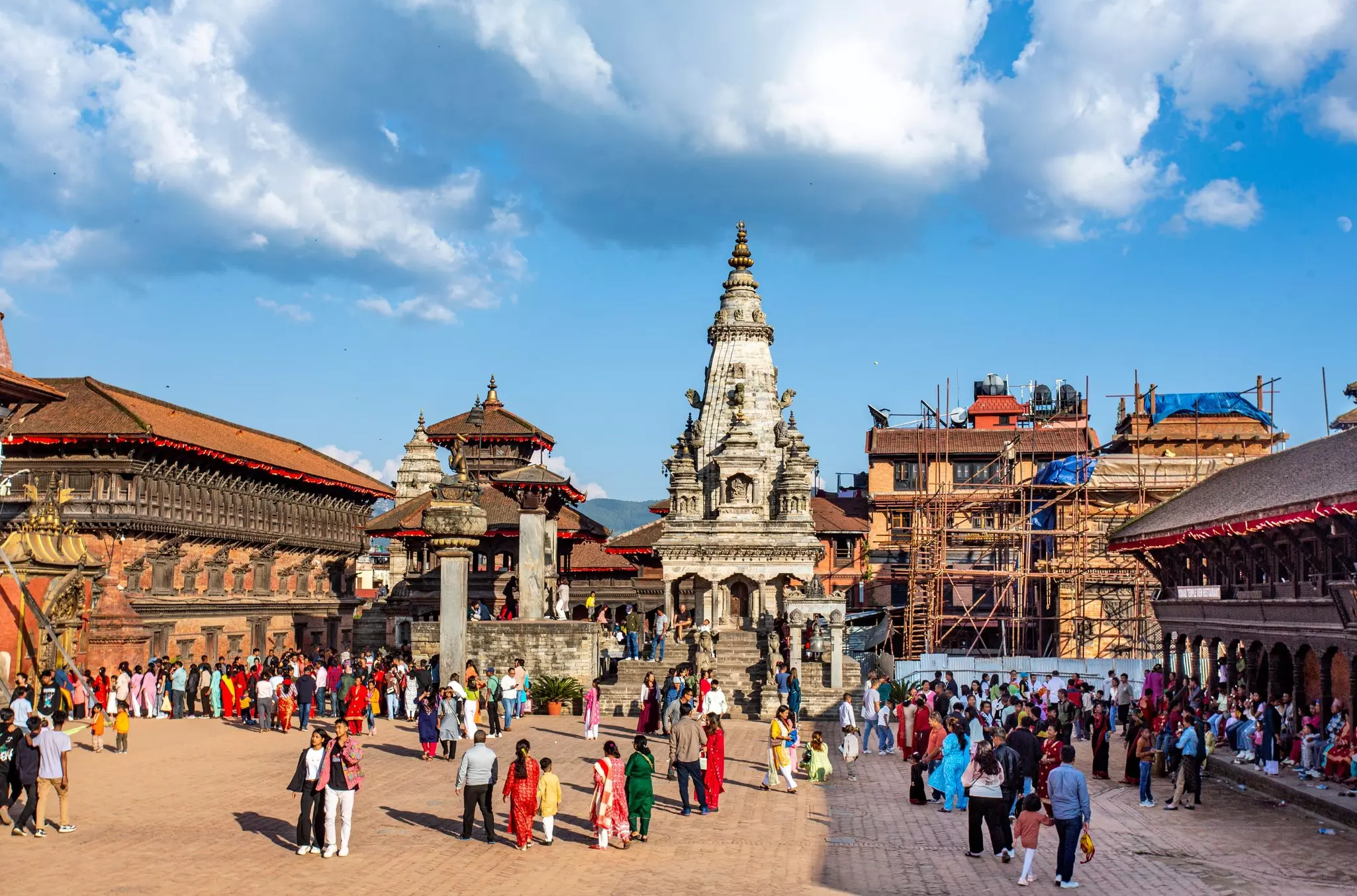 A busy city square surrounded by temples and stupas.