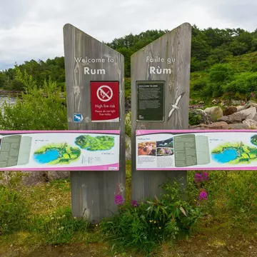 Isle of Rum, Inner Hebrides, Scotland.  July 14, 2023.  Colourful Welcome to the Isle of Rum information sign placed at the Pier for visitors arriving on the island.  Horizontal.  Copy space, License Type: media, Download Time: 2024-11-13T02:49:03.000Z, User: claramonitto, Editorial: true, purchase_order: 56530 - Guidebooks, job: Global Publishing-WIP, client: Scotland 13, other: Clara Monitto