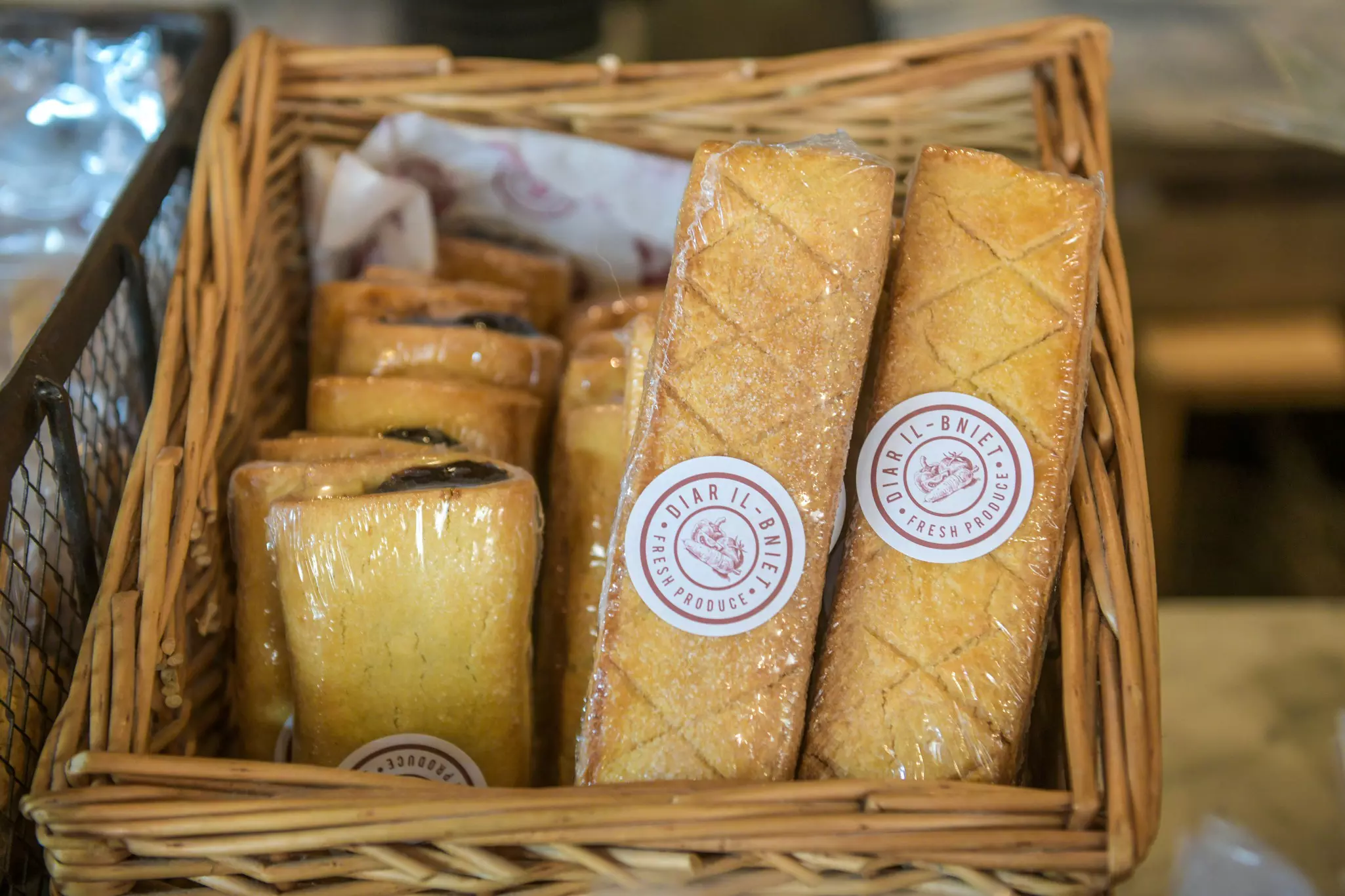 A basket full of pastry-based snacks wrapped in plastic.