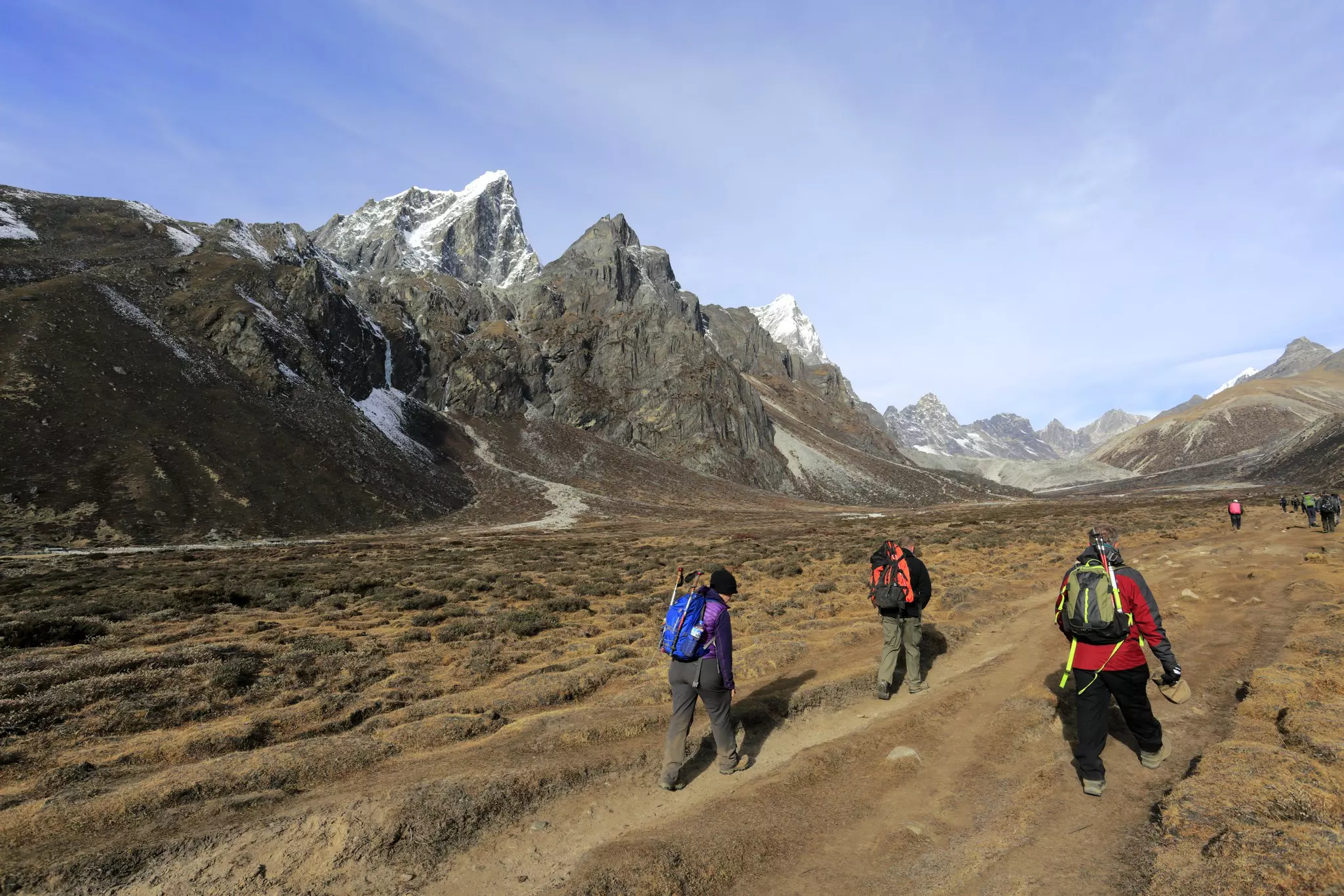 Trekkers walking along the wide valley at Pheriche, on the Everest Base Camp trekking route, Nepal.