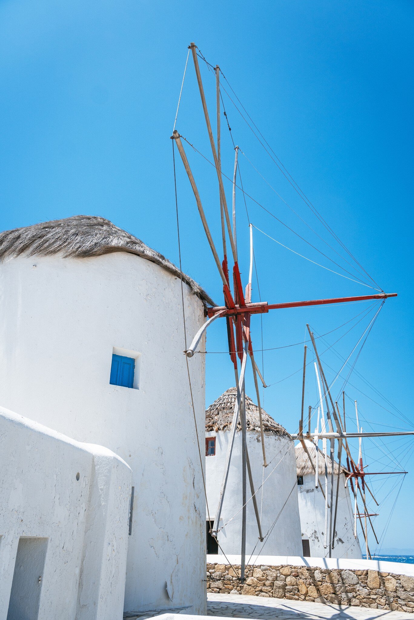 View of the famous whitewashed windmills on the island of Mykonos in Greece.