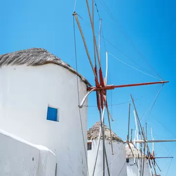 View of the famous whitewashed windmills on the island of Mykonos in Greece.