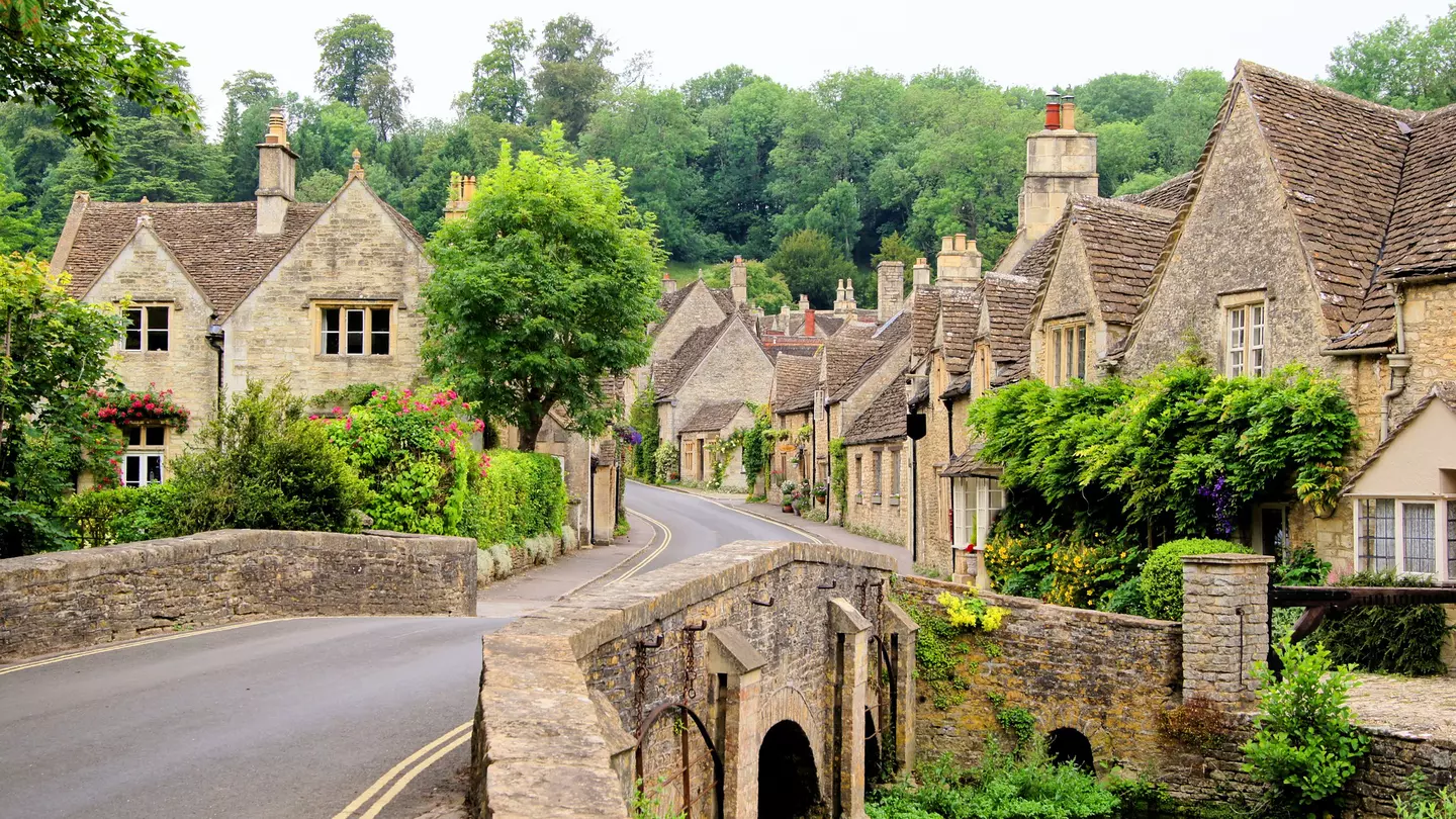 A traditional village, with a narrow street lined with stone cottages