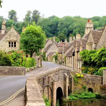 A traditional village, with a narrow street lined with stone cottages