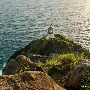 A lighthouse on a rocky outcrop.