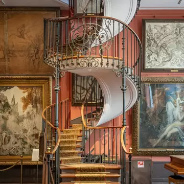 Paris, France - 06 08 2025: Gustave Moreau Museum. Detail view of the Artist's studio with its majestic spiral staircase, bay windows, paintings hanging on the walls and a wooden parquet floor , License Type: media, Download Time: 2025-08-04T18:59:27.000Z, User: rhylton_redventures, Editorial: true, purchase_order: 65050 - Digital Destinations and Articles, job: Lonely Planet, client: wip, other: app downloads