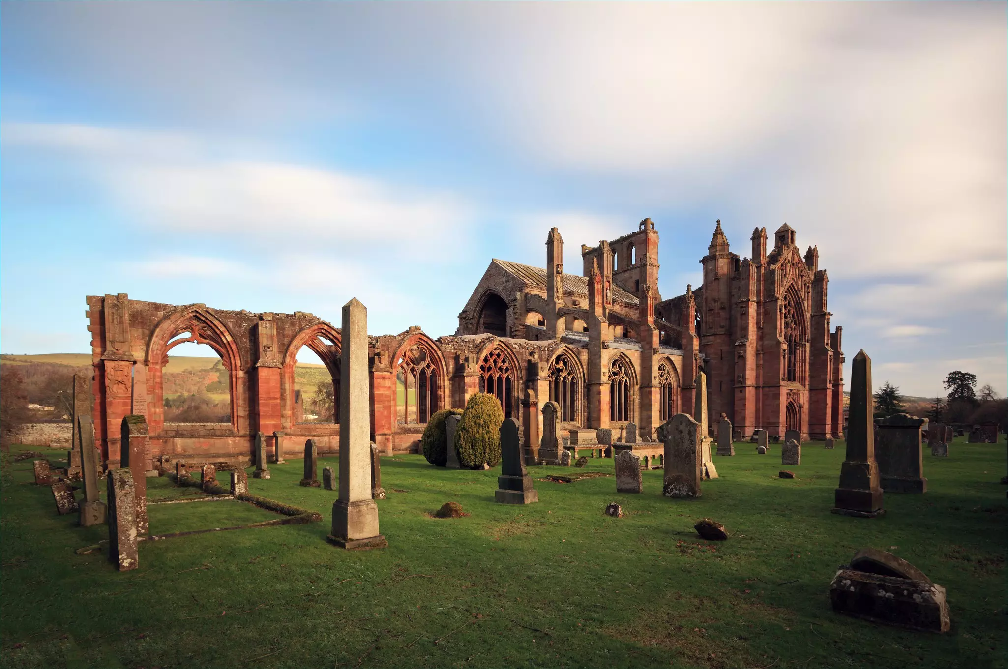 The ruins of Melrose Abbey with archways and crumbling walls