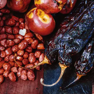Much of Peru's cooking begins and ends with the humble potato, but other staple ingredients include chilis, corn and quinoa. Gustavo Ramirez / Getty Images