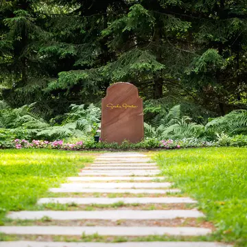 Stockholm, Sweden - June 30, 2016: Greta Garbo's gravestone at Skogskyrkogården, Stockholm, Sweden. The Swedish-born Hollywood actress died in New York City in 1990. Her ashes were interred at  Skogskyrkogården Cemetery in 1990.