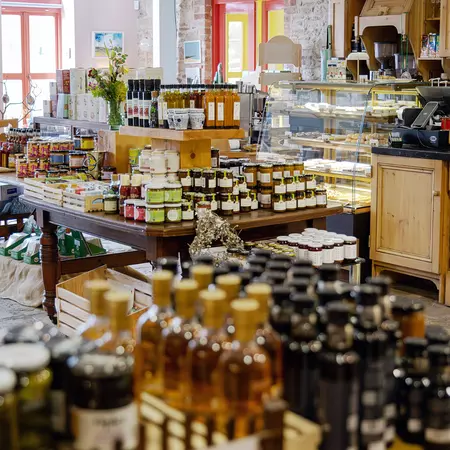 Interior of The Blue Goat farm shop with tables covered in produce in Ramelton, County Donegal, Ireland.