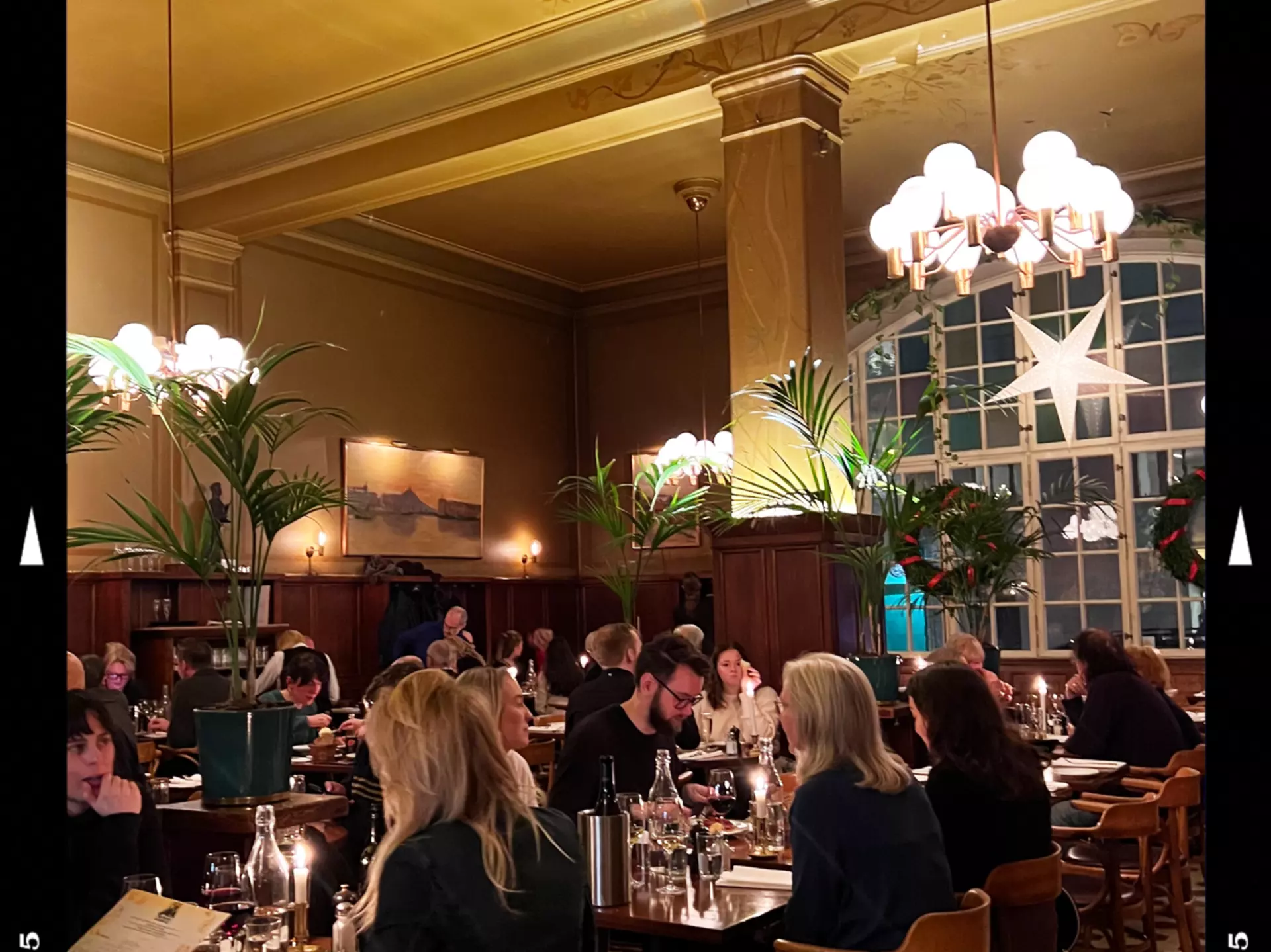 A dinner scene in a dimly-lit and elegant restaurant in Stockholm