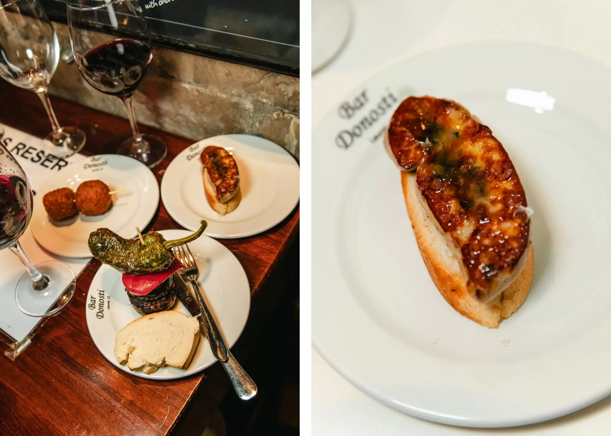 Left: Various pinchos on plates on a wood table with two dark wines nearby Right: A closer look at a fried pincho on a white plate with the Bar Donosti's name. on its rim
