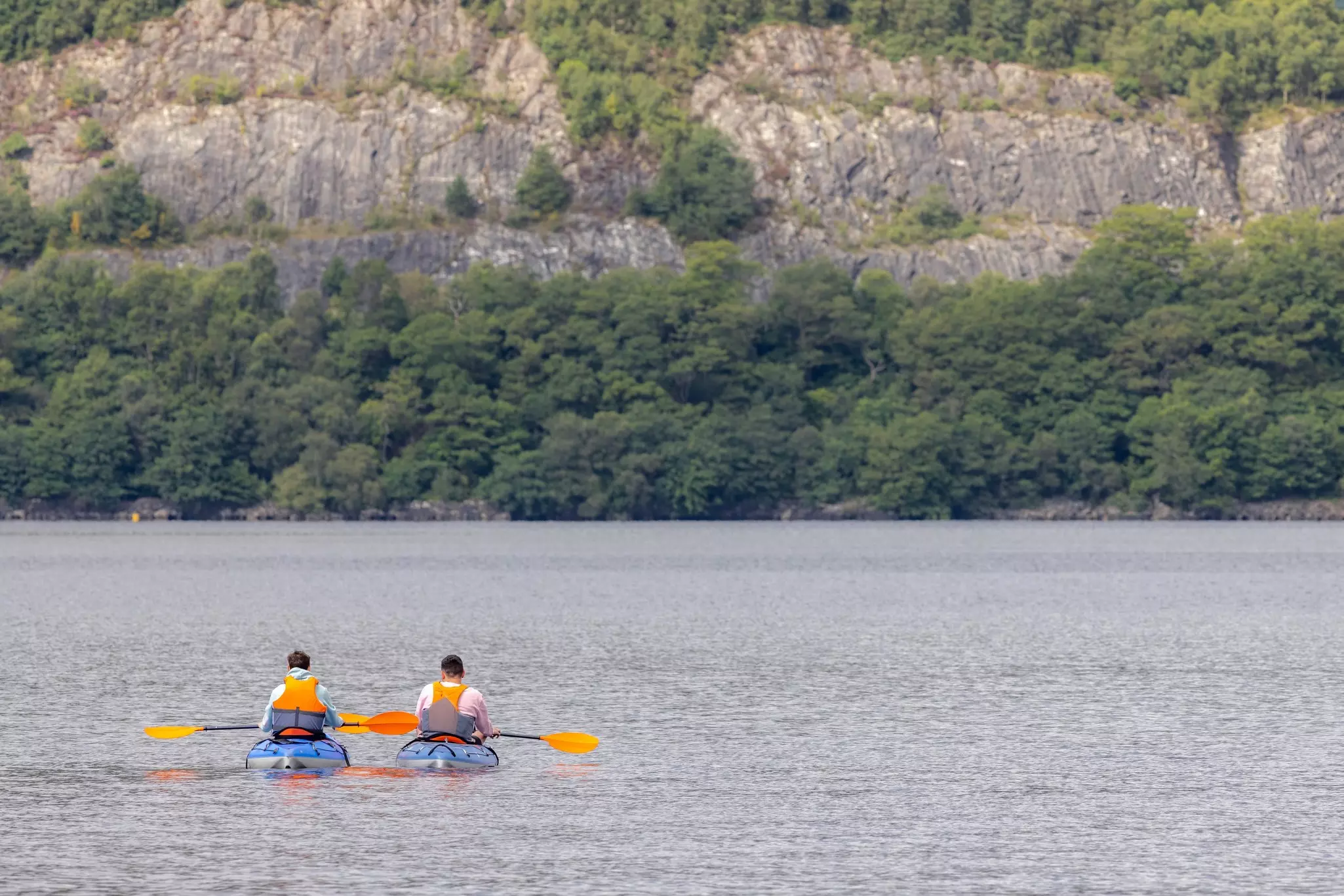 Kayakers resting on open water at Loch Lomond & The Trossachs National Park, Scotland, UK.